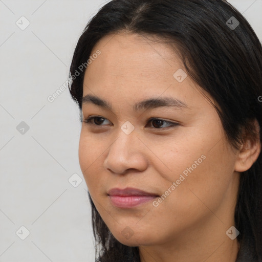 Joyful asian young-adult female with long  brown hair and brown eyes