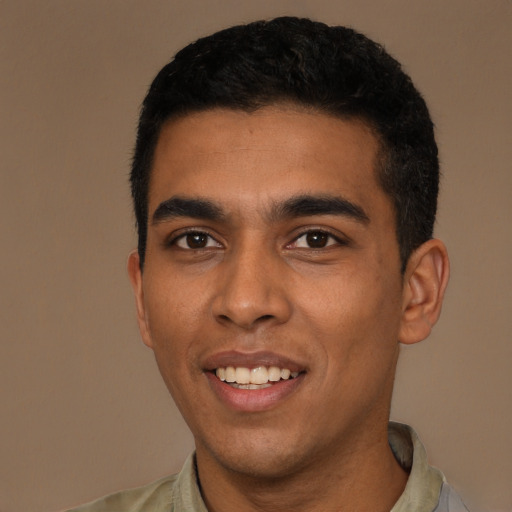 Joyful latino young-adult male with short  black hair and brown eyes