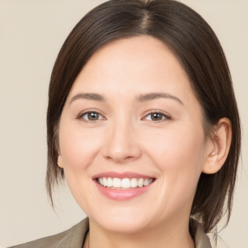 Joyful white young-adult female with medium  brown hair and brown eyes