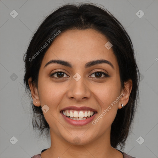 Joyful latino young-adult female with medium  brown hair and brown eyes