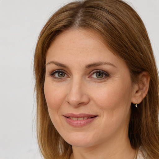 Joyful white adult female with long  brown hair and grey eyes