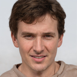 Joyful white adult male with short  brown hair and grey eyes