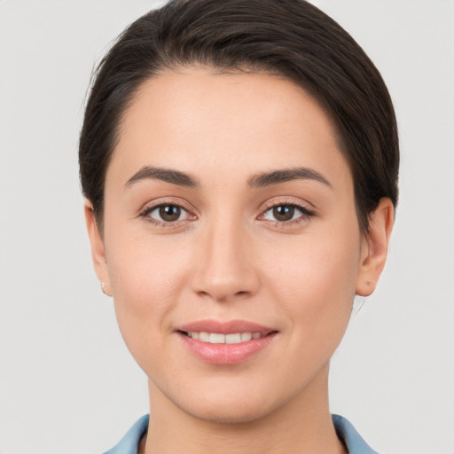 Joyful white young-adult female with short  brown hair and brown eyes