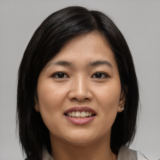 Joyful asian young-adult female with medium  brown hair and brown eyes