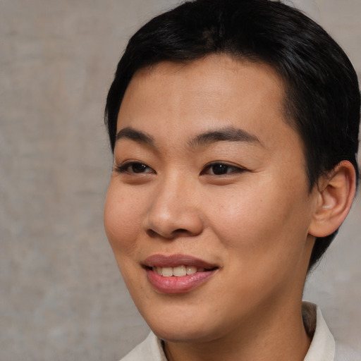 Joyful asian young-adult female with short  brown hair and brown eyes