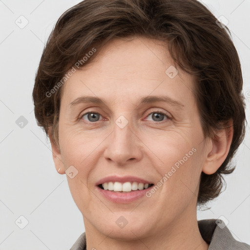 Joyful white adult female with short  brown hair and grey eyes