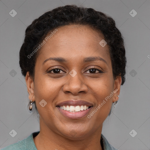 Joyful black adult female with short  brown hair and brown eyes