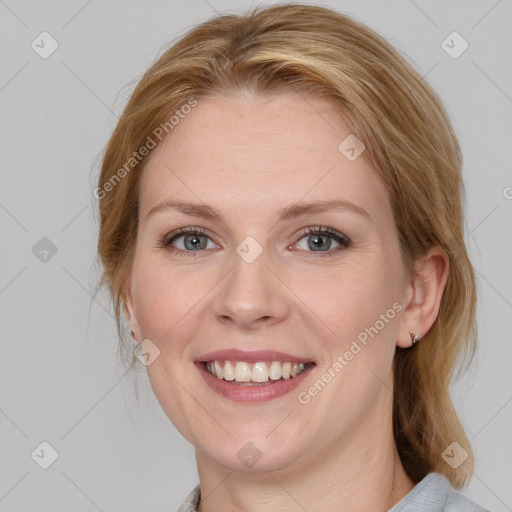 Joyful white young-adult female with medium  brown hair and blue eyes