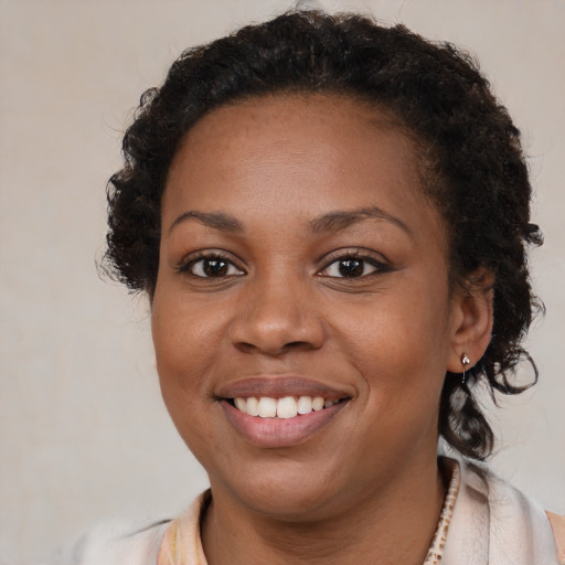 Joyful black young-adult female with medium  brown hair and brown eyes