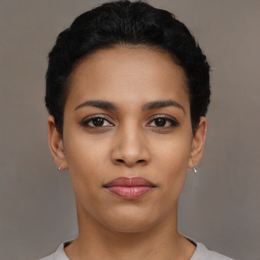 Joyful latino young-adult female with short  black hair and brown eyes
