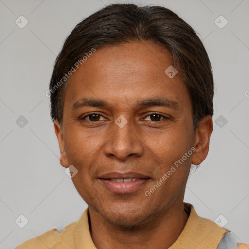 Joyful latino adult male with short  brown hair and brown eyes