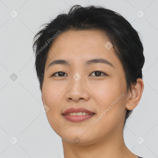 Joyful asian young-adult female with short  brown hair and brown eyes