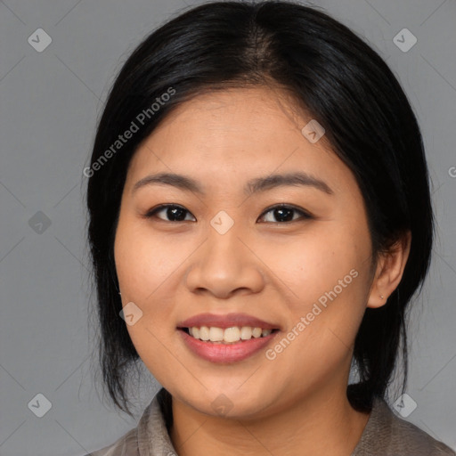 Joyful asian young-adult female with medium  black hair and brown eyes