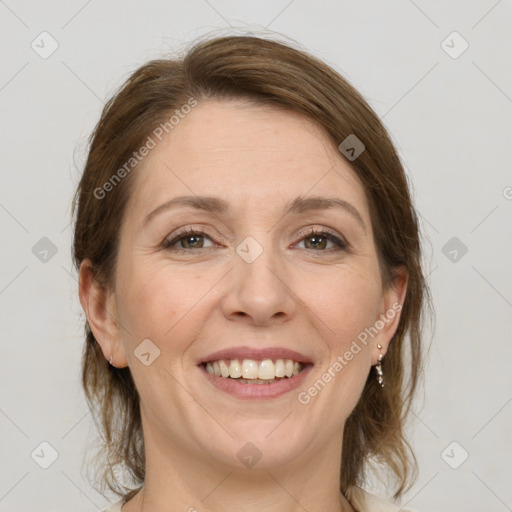 Joyful white adult female with medium  brown hair and grey eyes