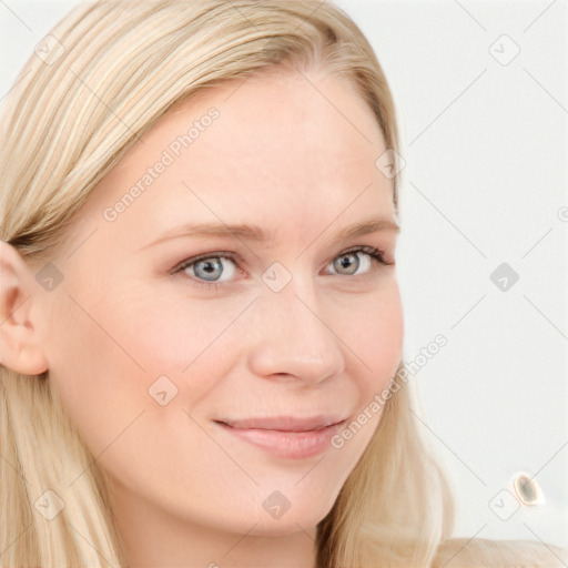 Joyful white young-adult female with long  brown hair and blue eyes