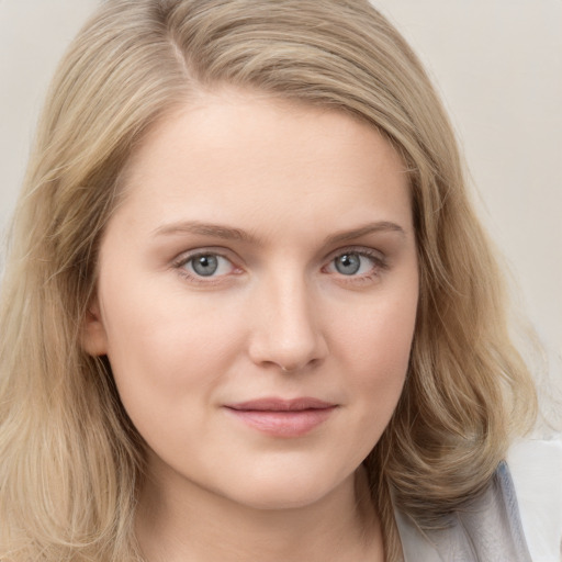 Joyful white young-adult female with long  brown hair and blue eyes