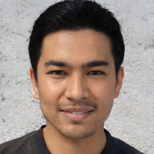 Joyful asian young-adult male with short  black hair and brown eyes