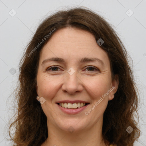 Joyful white adult female with long  brown hair and brown eyes