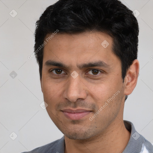 Joyful white young-adult male with short  black hair and brown eyes