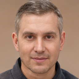 Joyful white adult male with short  brown hair and brown eyes