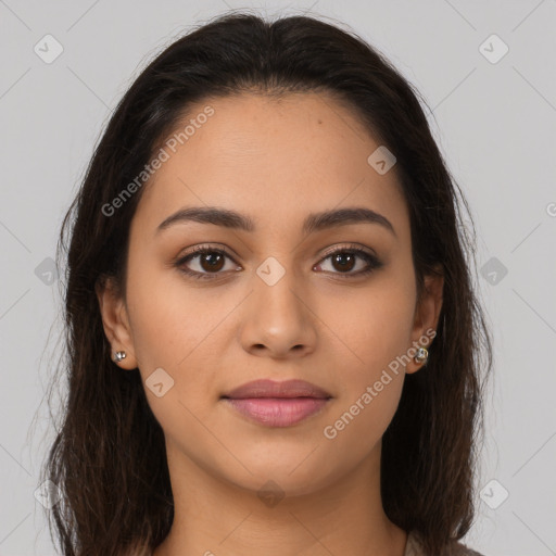 Joyful latino young-adult female with long  brown hair and brown eyes