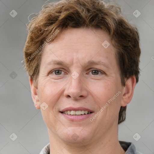 Joyful white adult male with short  brown hair and grey eyes