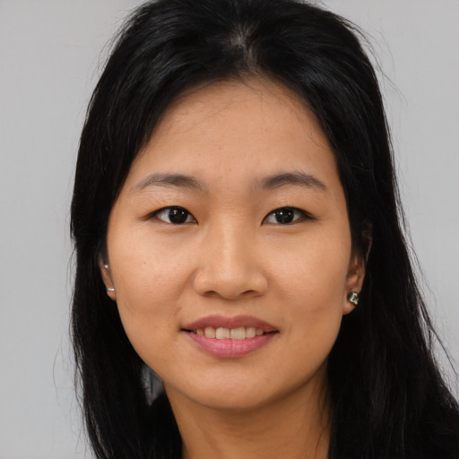 Joyful asian young-adult female with long  black hair and brown eyes