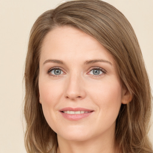 Joyful white young-adult female with long  brown hair and grey eyes