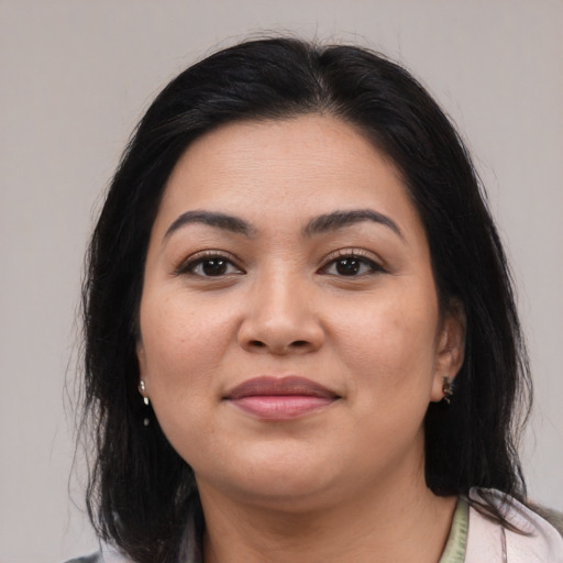Joyful latino young-adult female with medium  black hair and brown eyes