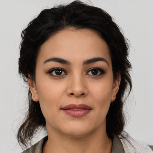 Joyful latino young-adult female with medium  brown hair and brown eyes