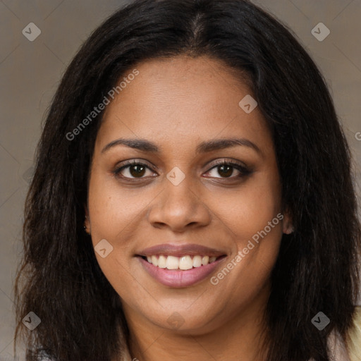 Joyful black young-adult female with long  brown hair and brown eyes