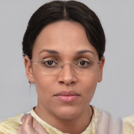 Joyful latino adult female with medium  brown hair and brown eyes