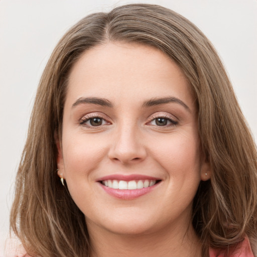 Joyful white young-adult female with long  brown hair and grey eyes