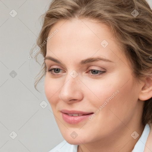 Joyful white young-adult female with medium  brown hair and blue eyes