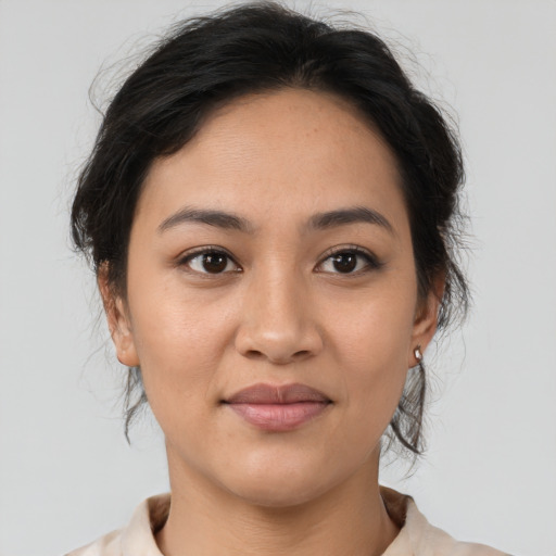 Joyful asian young-adult female with medium  brown hair and brown eyes
