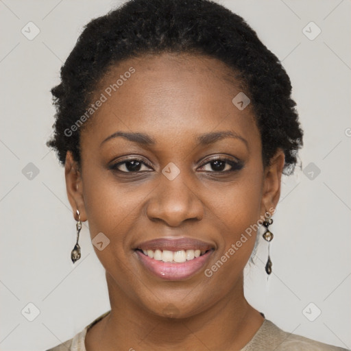 Joyful black young-adult female with short  black hair and brown eyes