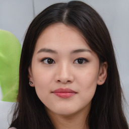 Joyful asian young-adult female with long  brown hair and brown eyes