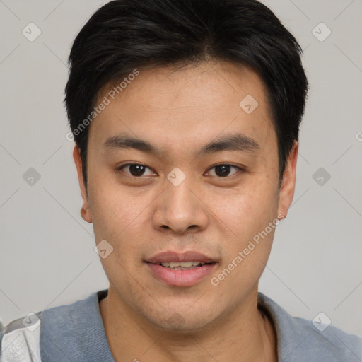 Joyful asian young-adult male with short  brown hair and brown eyes