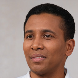 Joyful black young-adult male with short  black hair and brown eyes