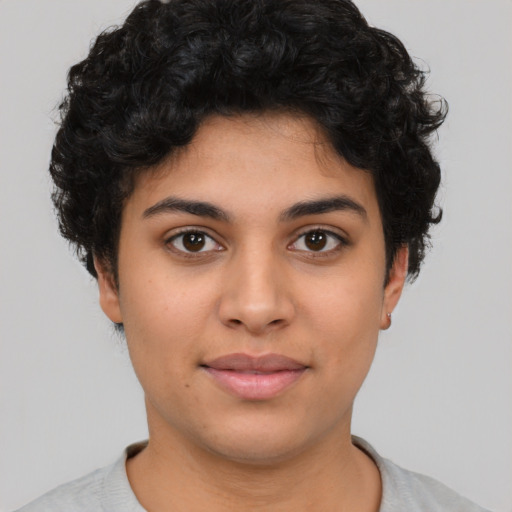 Joyful latino young-adult female with short  black hair and brown eyes