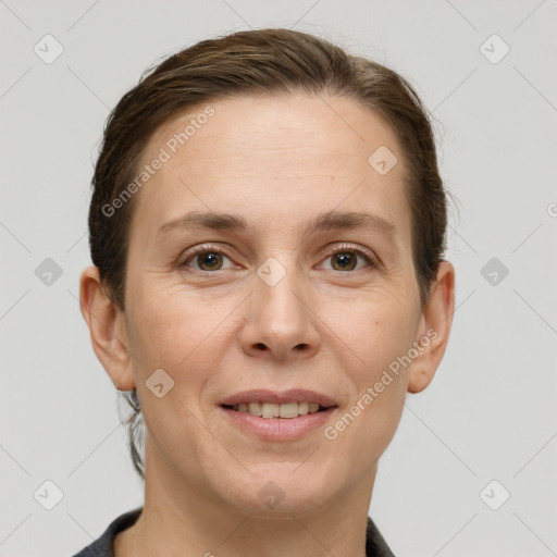 Joyful white adult female with short  brown hair and grey eyes