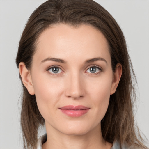 Joyful white young-adult female with medium  brown hair and grey eyes