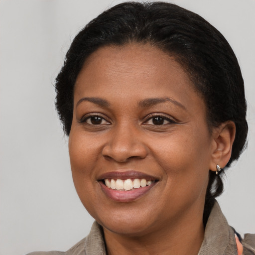 Joyful black young-adult female with medium  brown hair and brown eyes