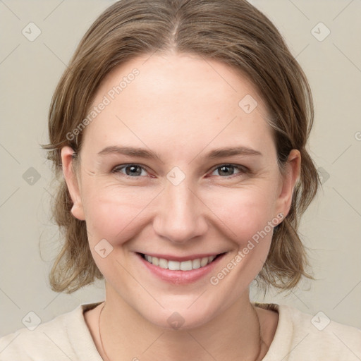 Joyful white young-adult female with medium  brown hair and grey eyes