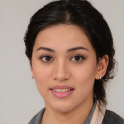 Joyful latino young-adult female with medium  brown hair and brown eyes