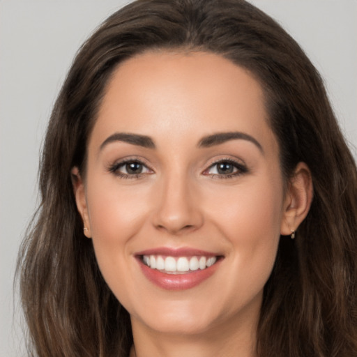 Joyful white young-adult female with long  brown hair and brown eyes