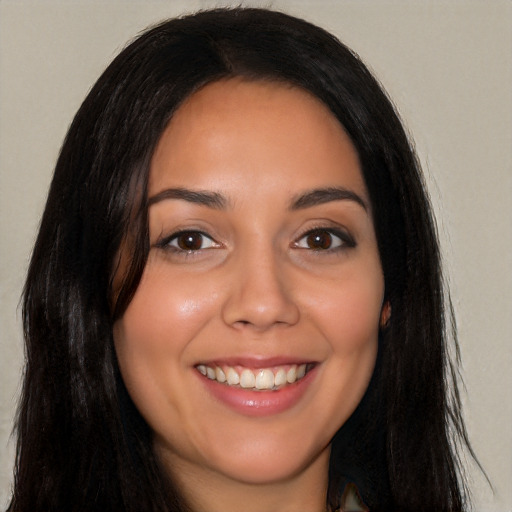 Joyful latino young-adult female with long  black hair and brown eyes