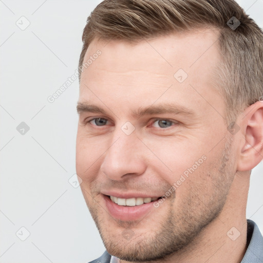 Joyful white young-adult male with short  brown hair and grey eyes