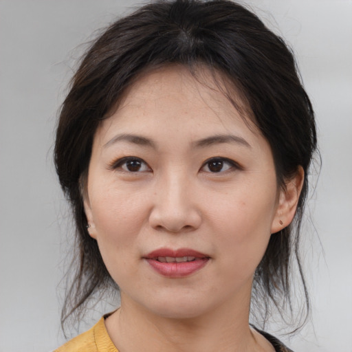 Joyful asian young-adult female with medium  brown hair and brown eyes
