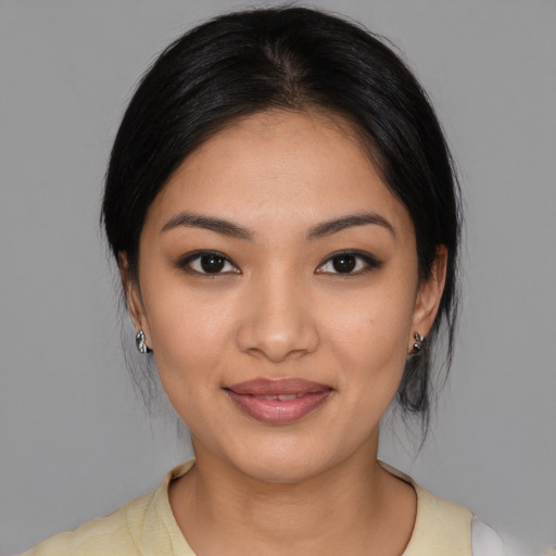 Joyful latino young-adult female with medium  black hair and brown eyes